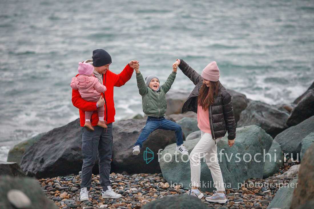 Семья у больших камней на фоне моря